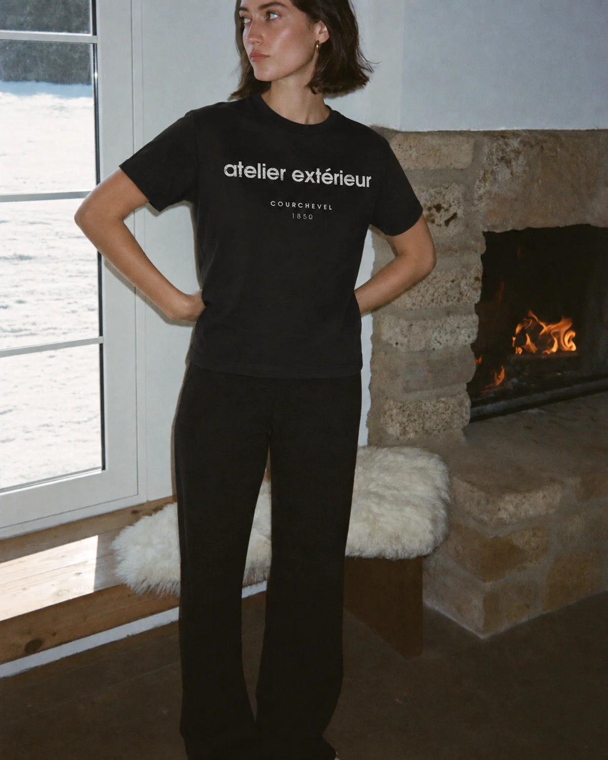 Woman wearing the 1850 Tee in black, on location