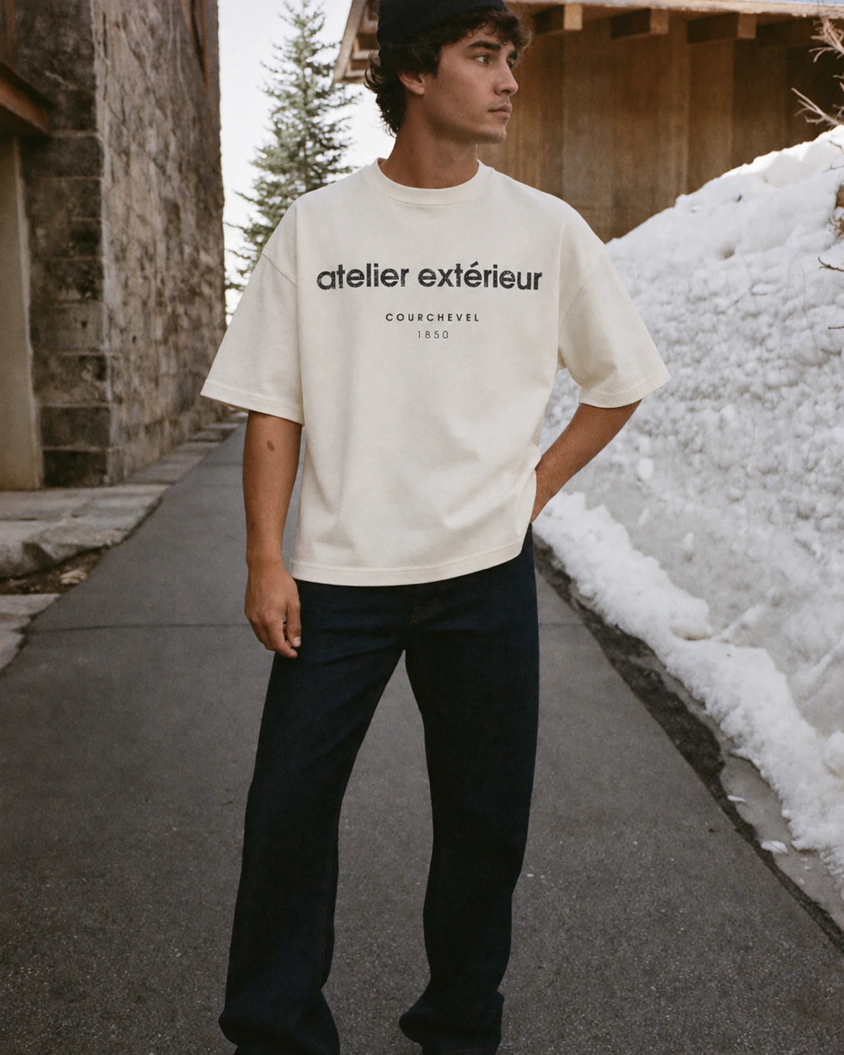 Man wearing the 1850 Tee in ecru, on location