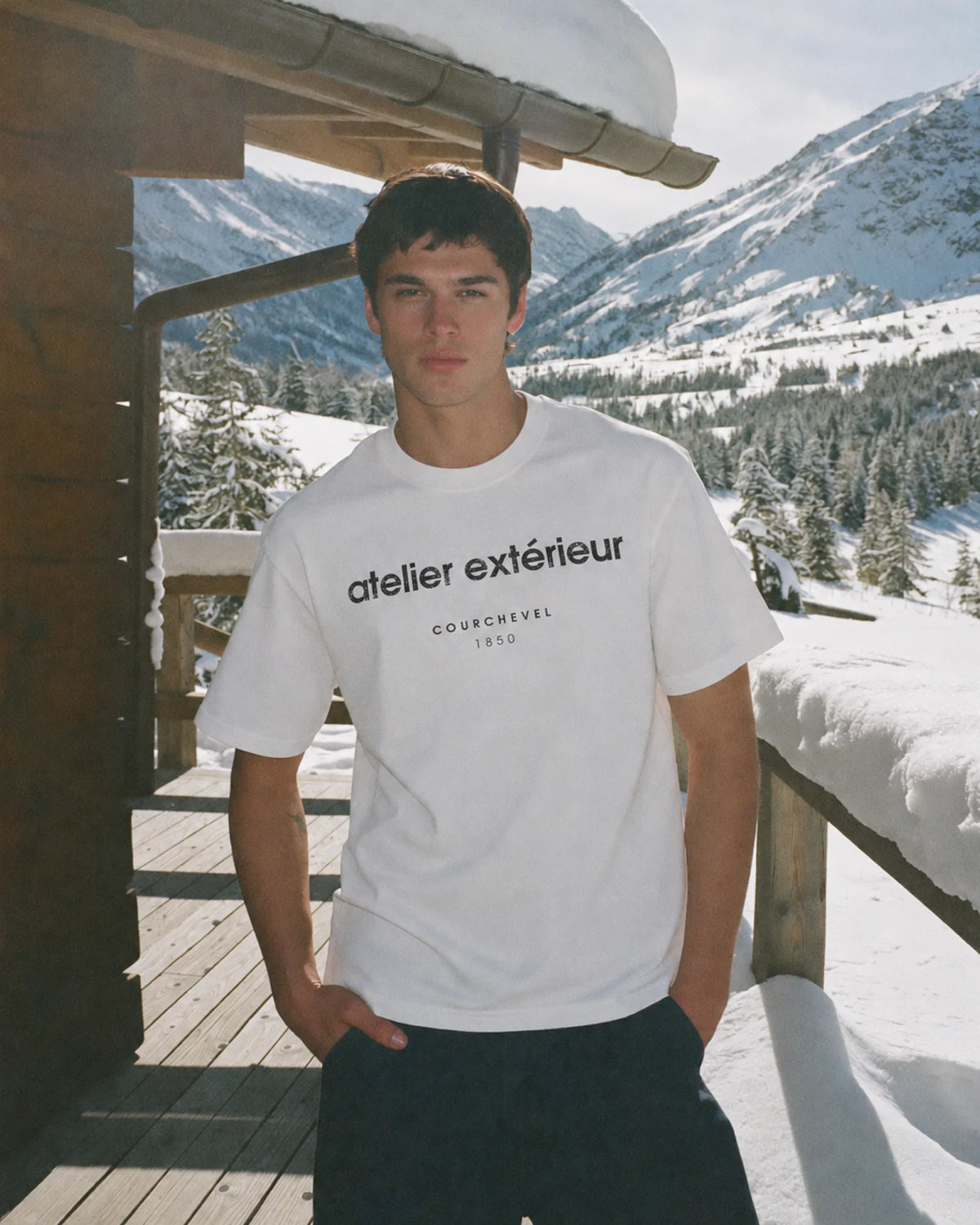 White Courchevel 1850 ski tee worn in an alpine chalet