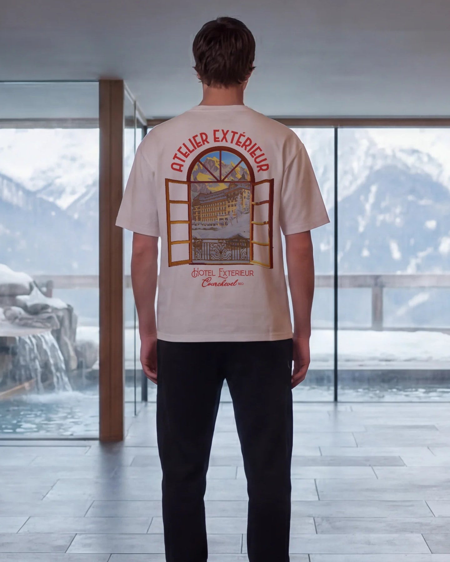 Person standing in a modern interior space with scenic view