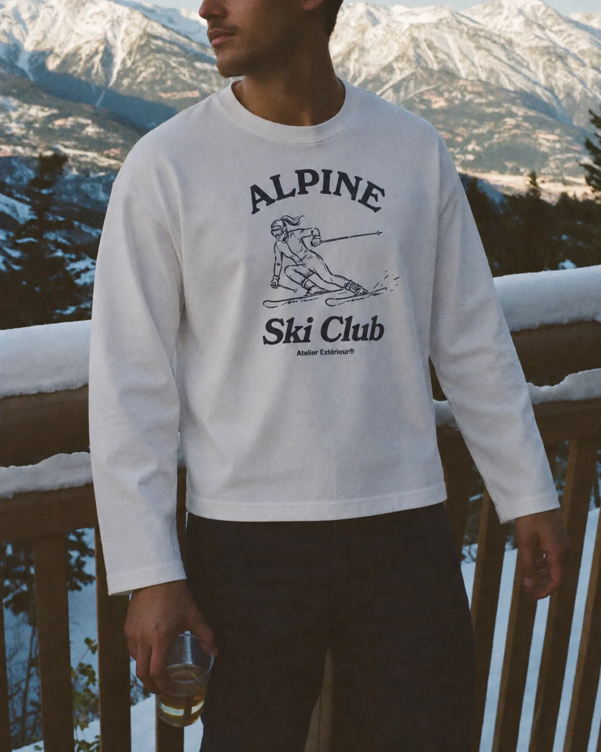 Man wearing the Alpine Ski Club Long Sleeve Tee in white, on location