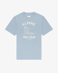 Alpine Ski Club women's tee in baby blue, front view, skier illustration under Alpine Ski Club lettering