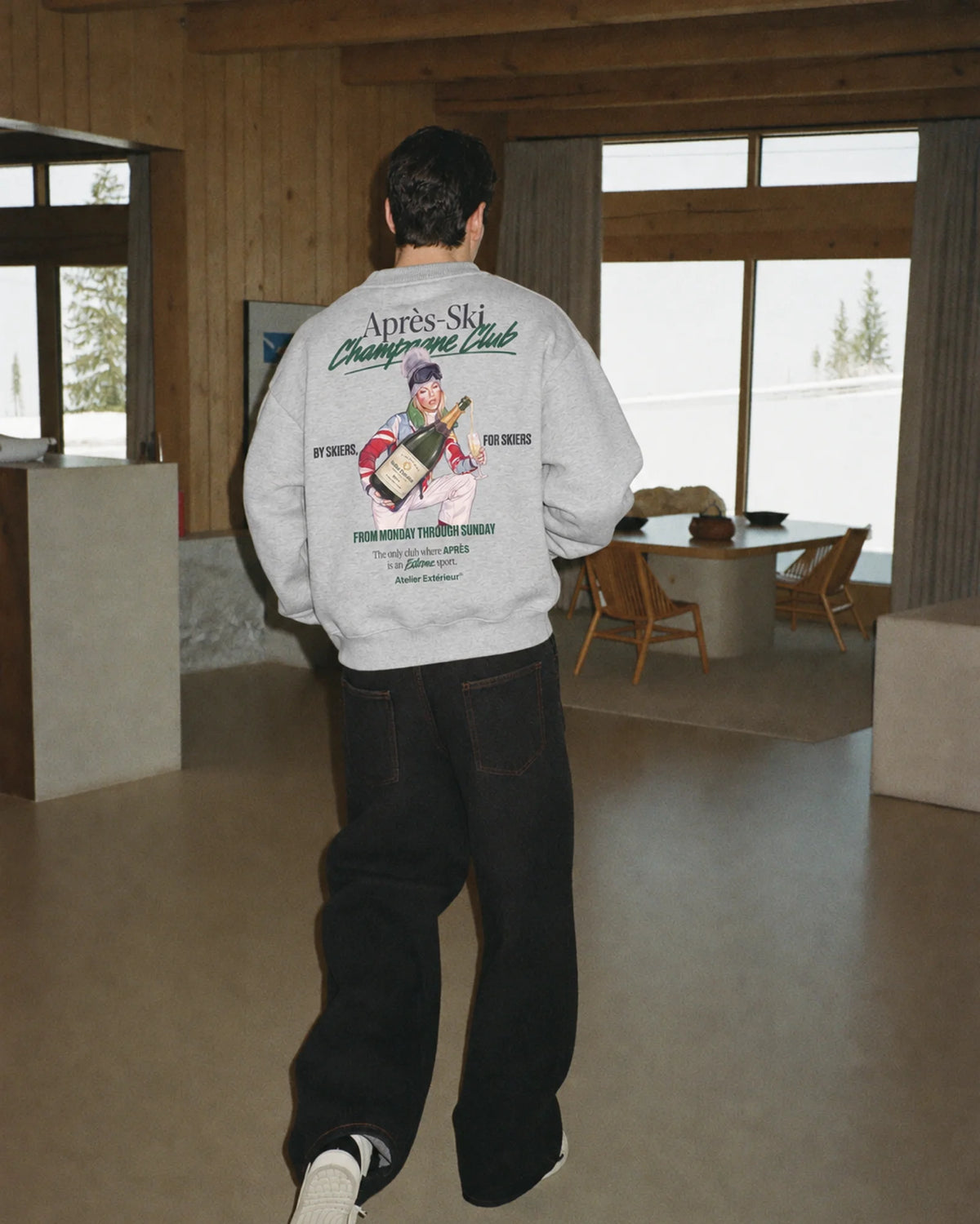 Man wearing the Après Ski Champagne Club Crewneck, on location