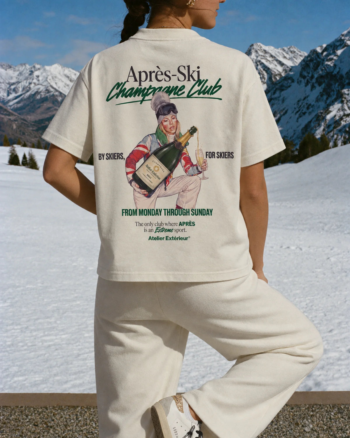 Woman wearing the Après Ski Champagne Club Tee in ecru, on location