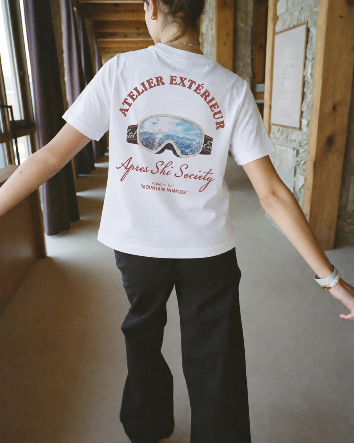 Woman wearing the Après Ski Society Tee, on location