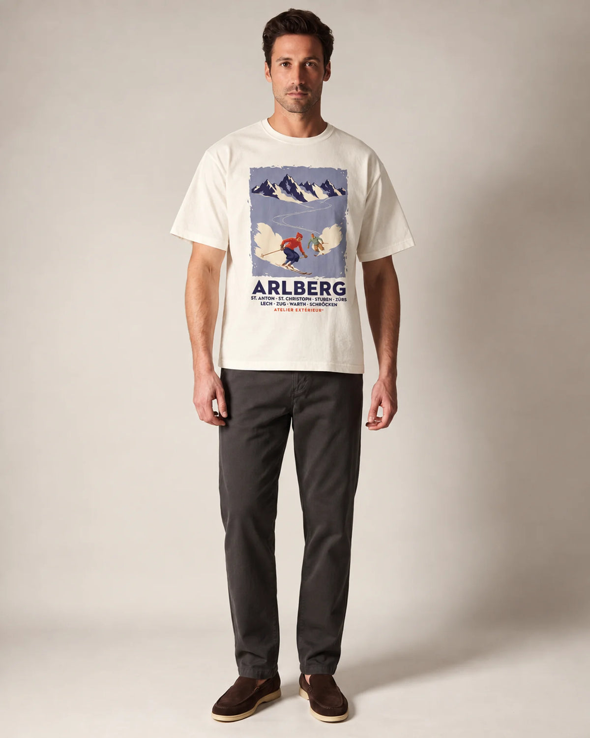 Model wearing the ecru Arlberg ski tee in a studio, front view