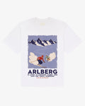 White cotton Arlberg tee, front view, with a vintage Arlberg ski poster print of two skiers below alpine peaks