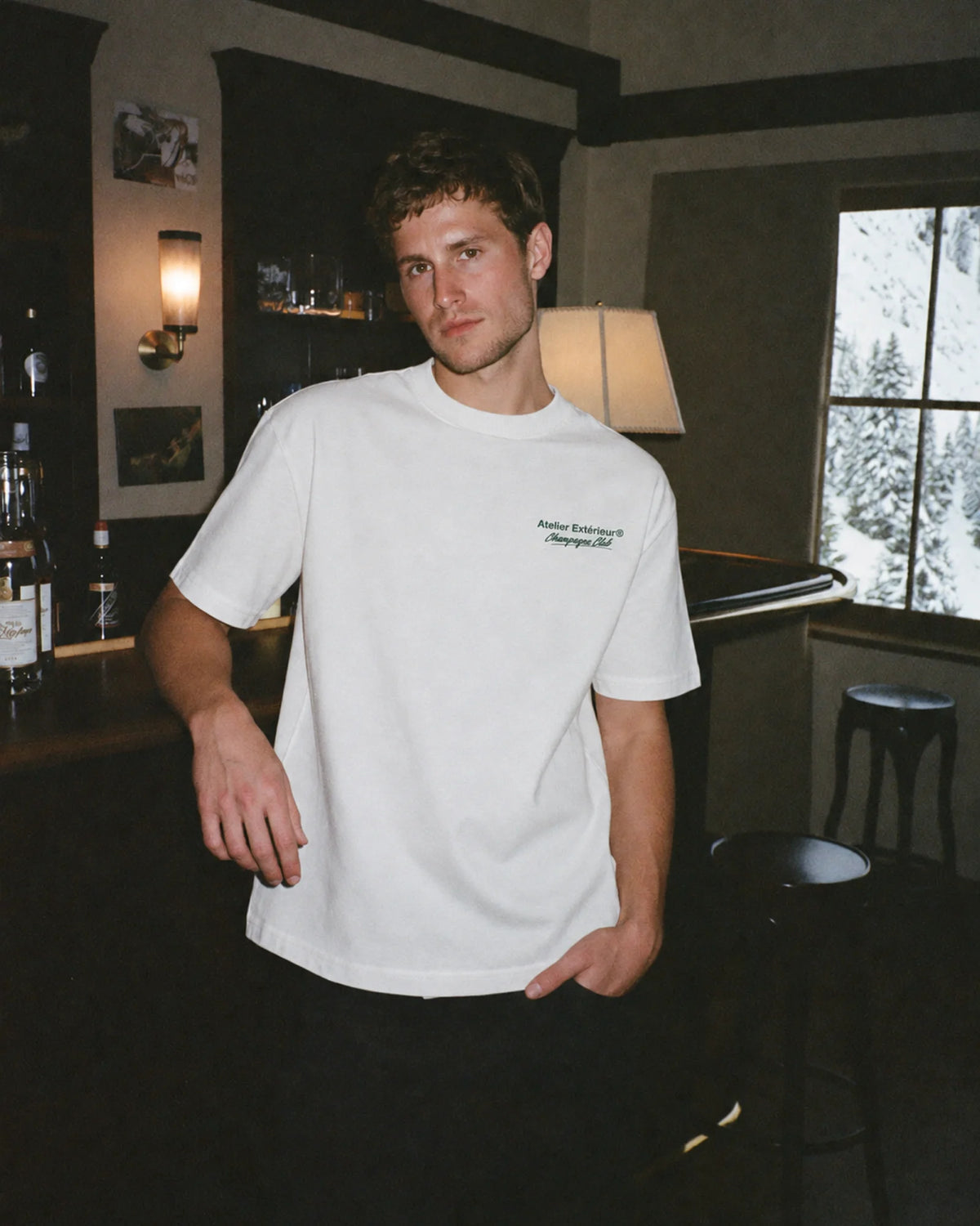 Man wearing the white Après Ski Champagne Club tee