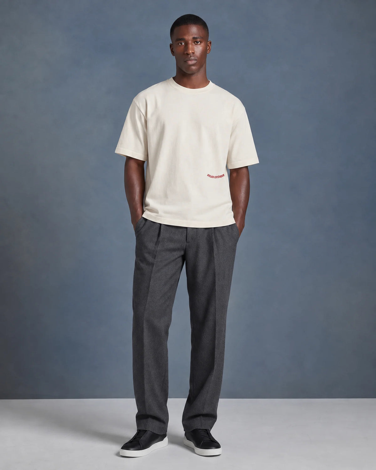 Model wearing the ecru Backflip tee in a studio, front view
