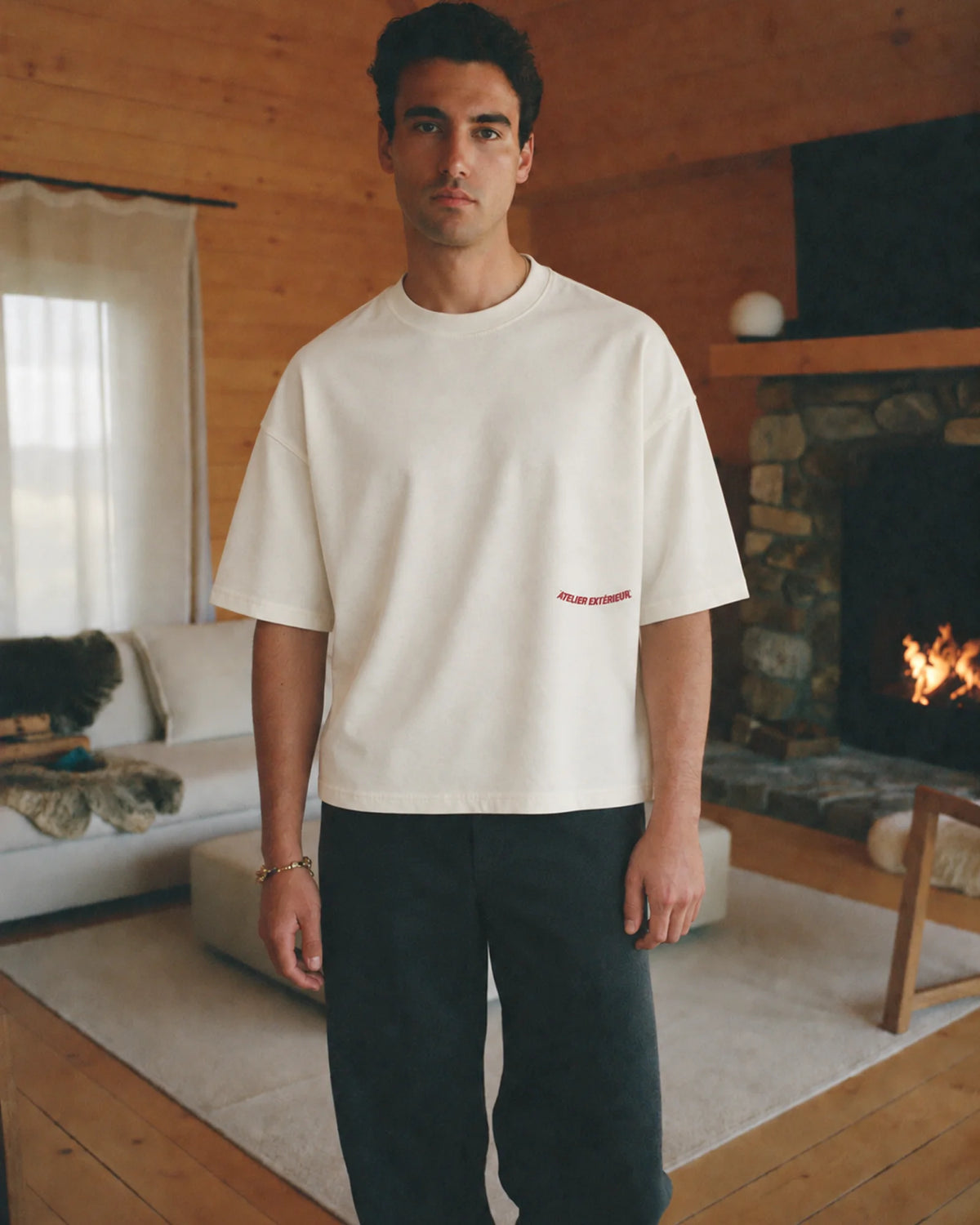 Man wearing the ecru Backflip tee outdoors, front view