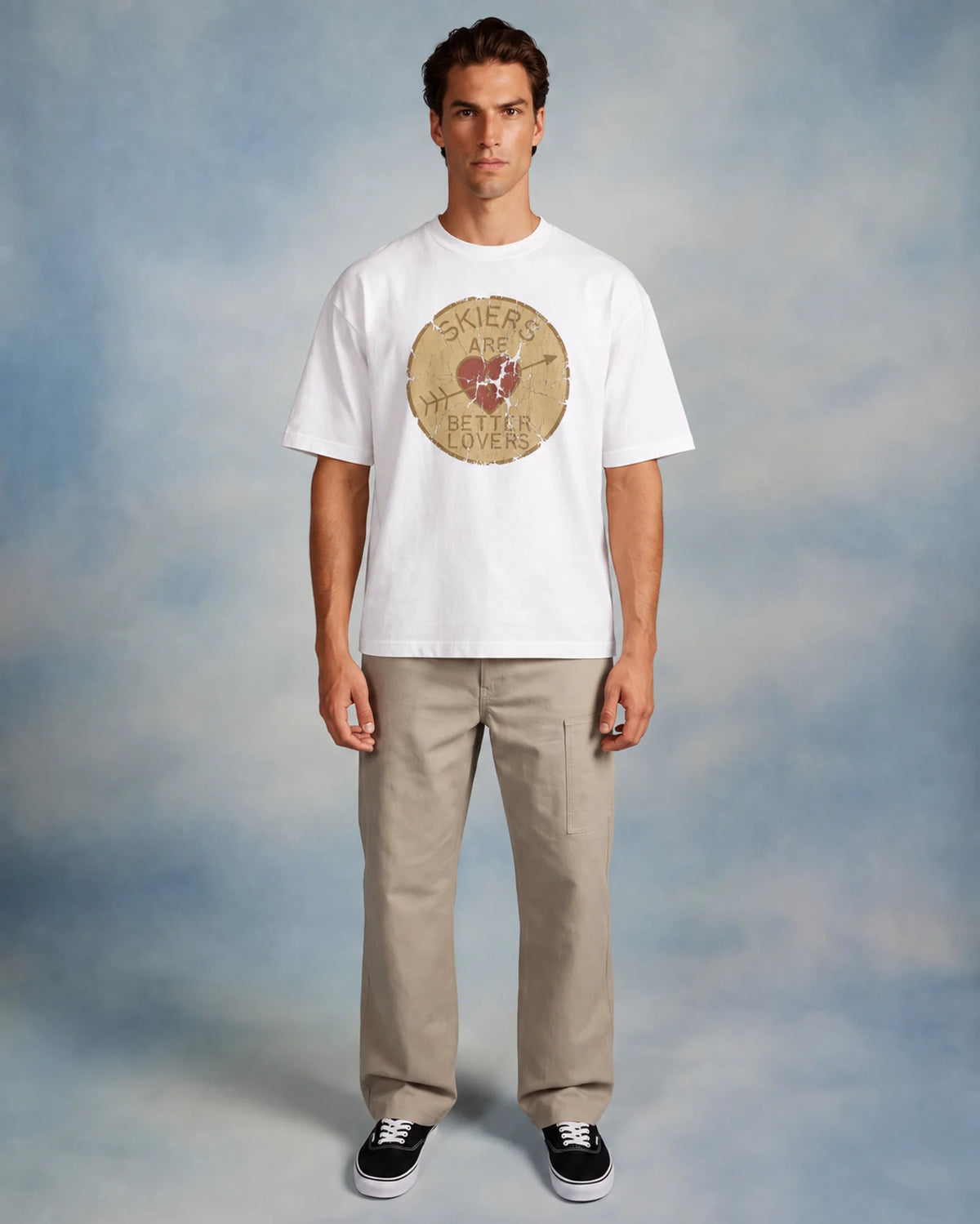 Model wearing the white Skiers Are Better Lovers tee in a studio, front view
