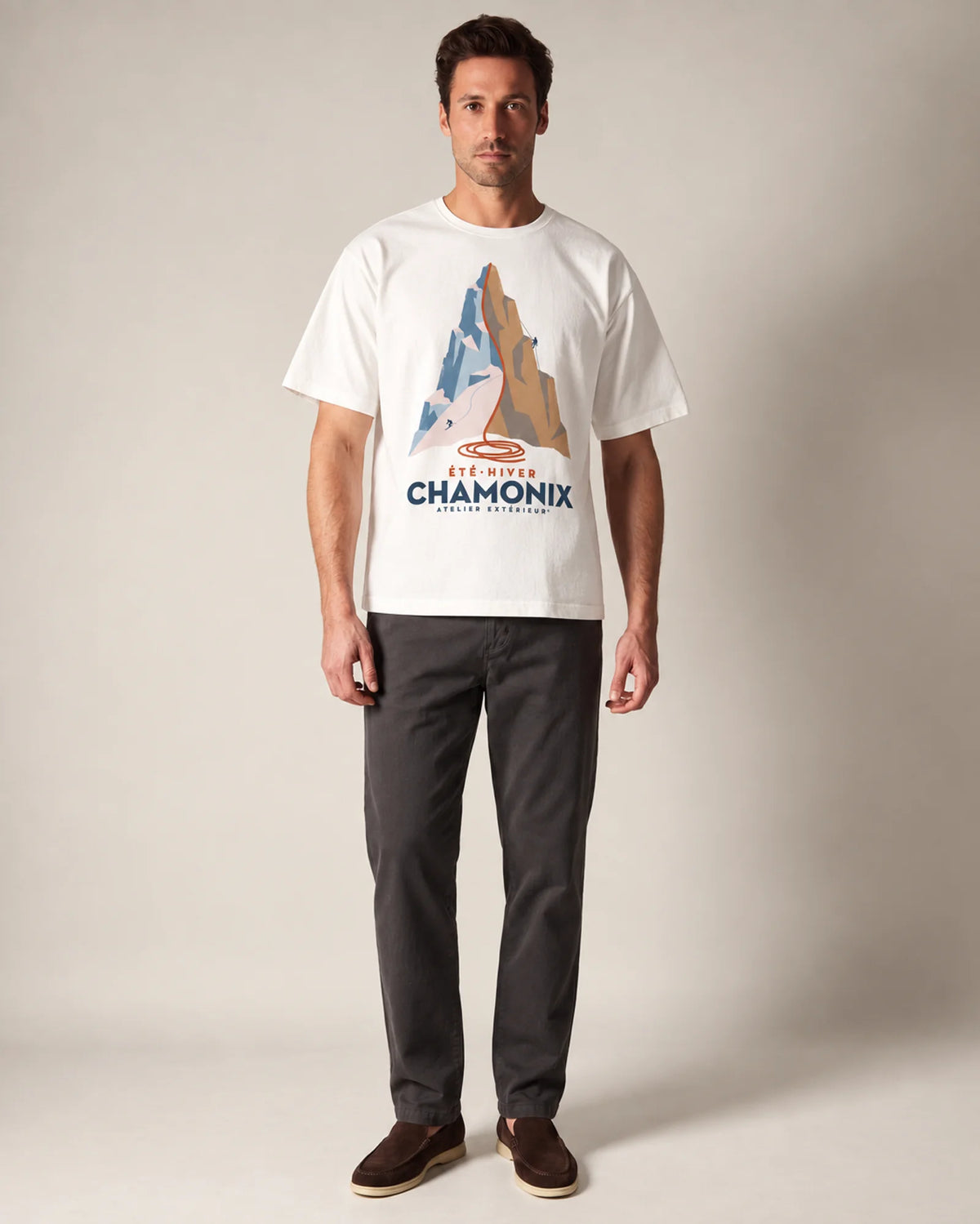 Model wearing the white Chamonix ski tee in a studio, front view