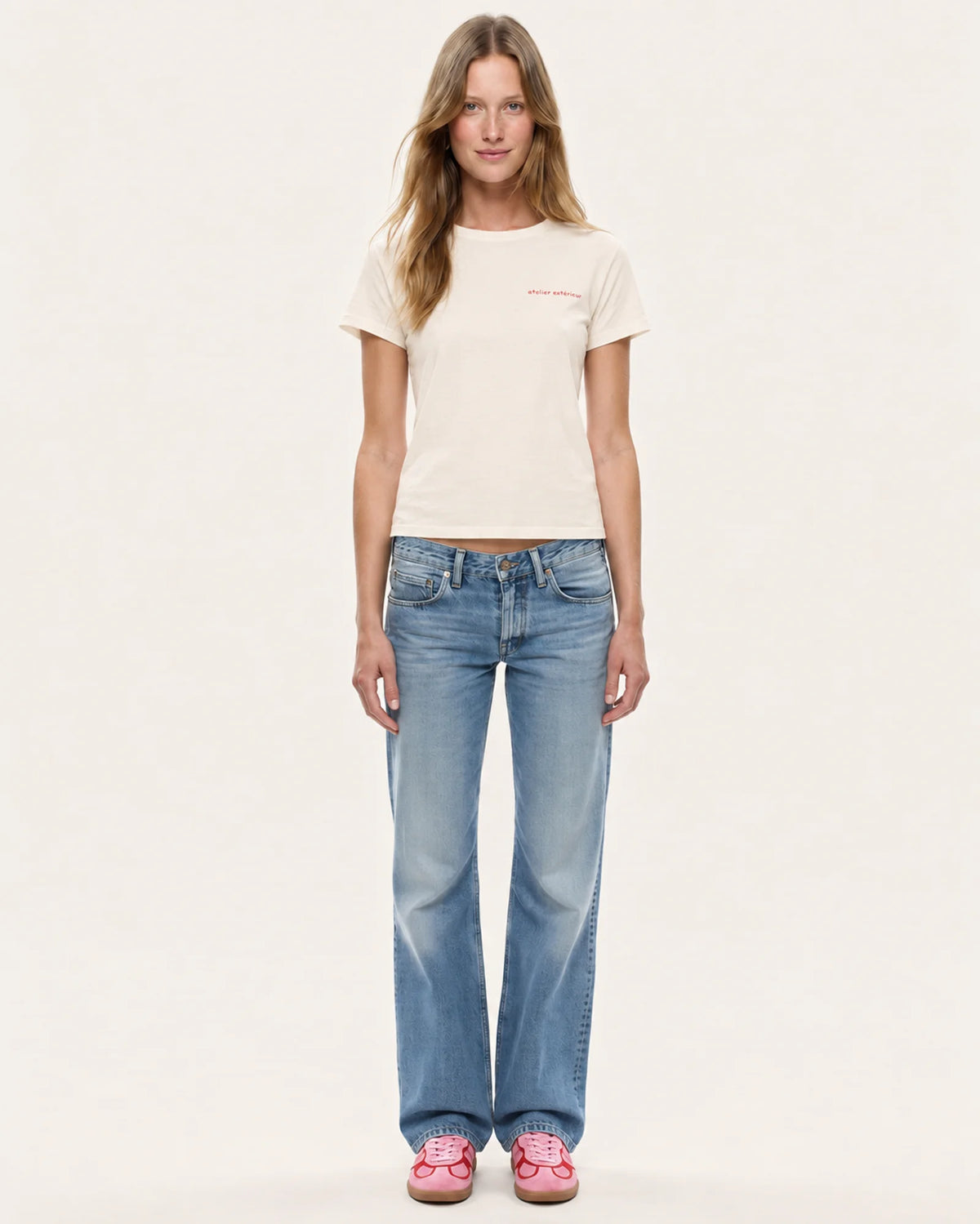 Model wearing the Champagne women's tee in ecru with straight-leg jeans, front view