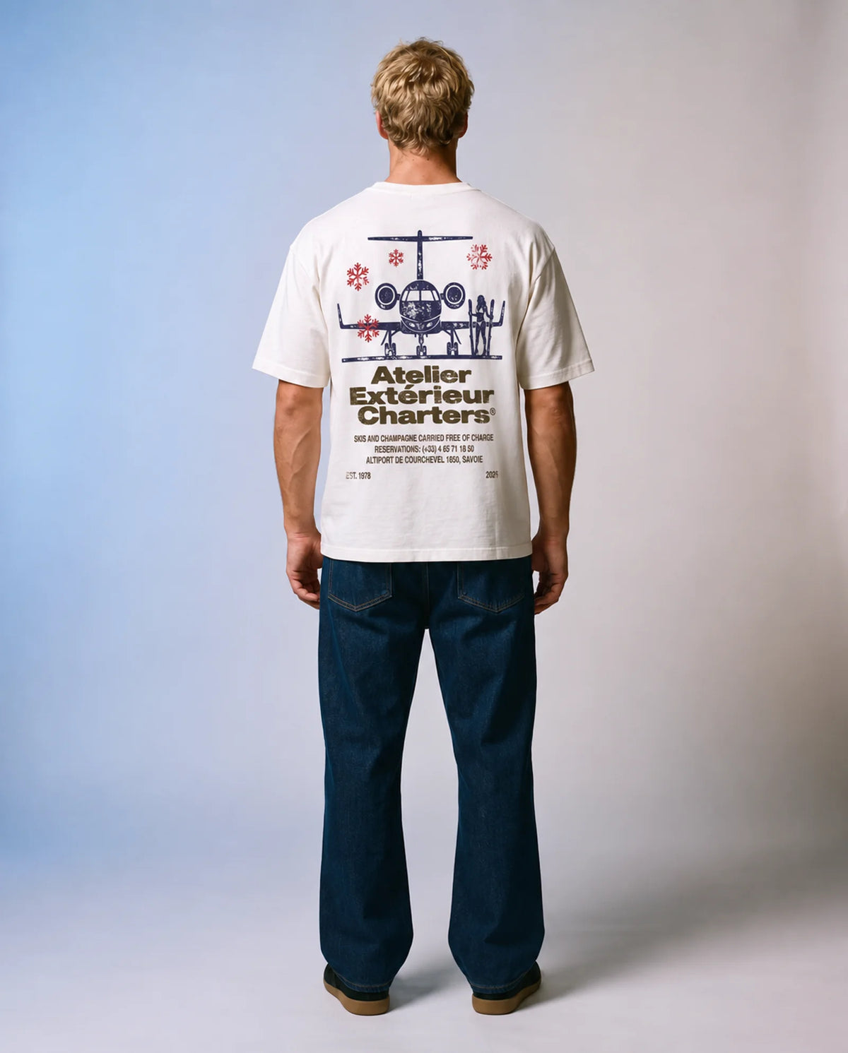 Model wearing the white Charters tee in a studio, back view
