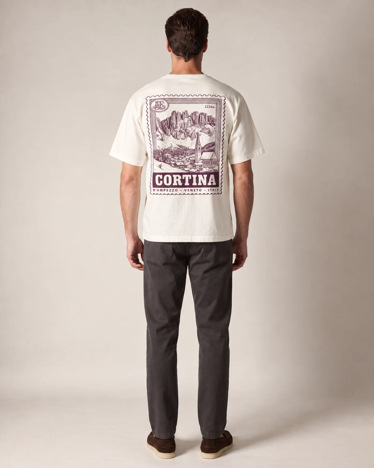 Model wearing the ecru Cortina tee in a studio, back view