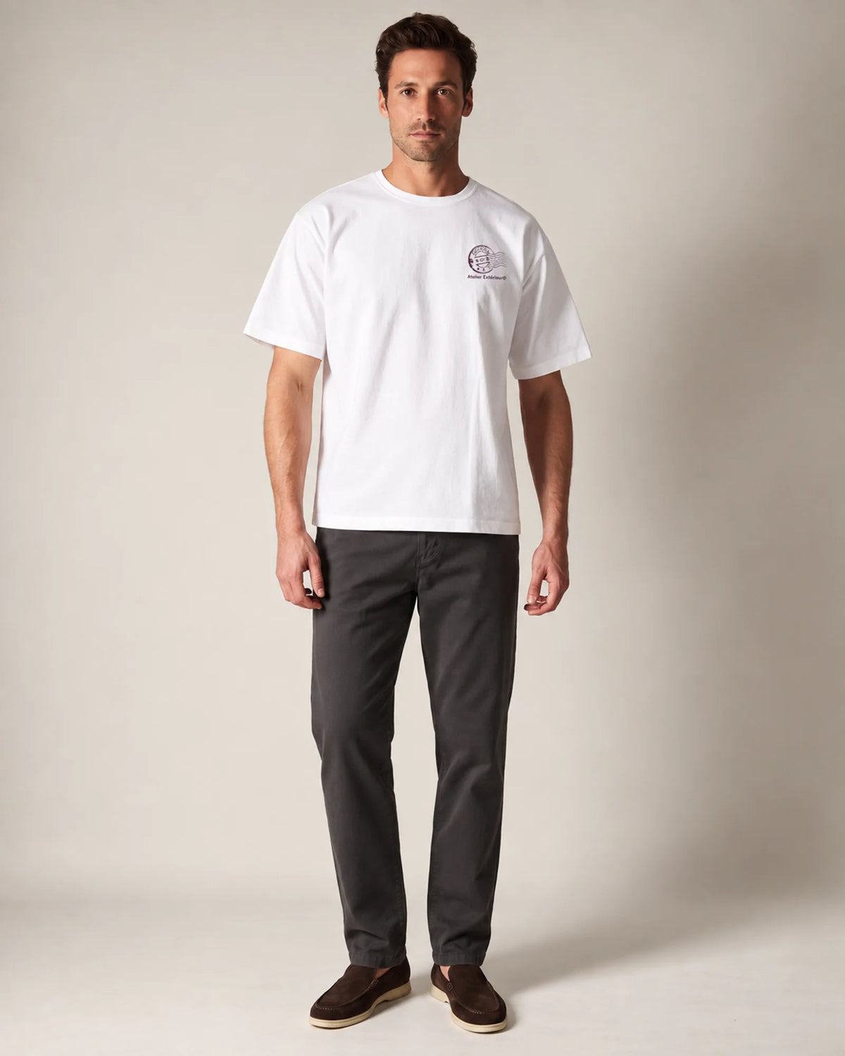 Model wearing the white Cortina tee in a studio, front view