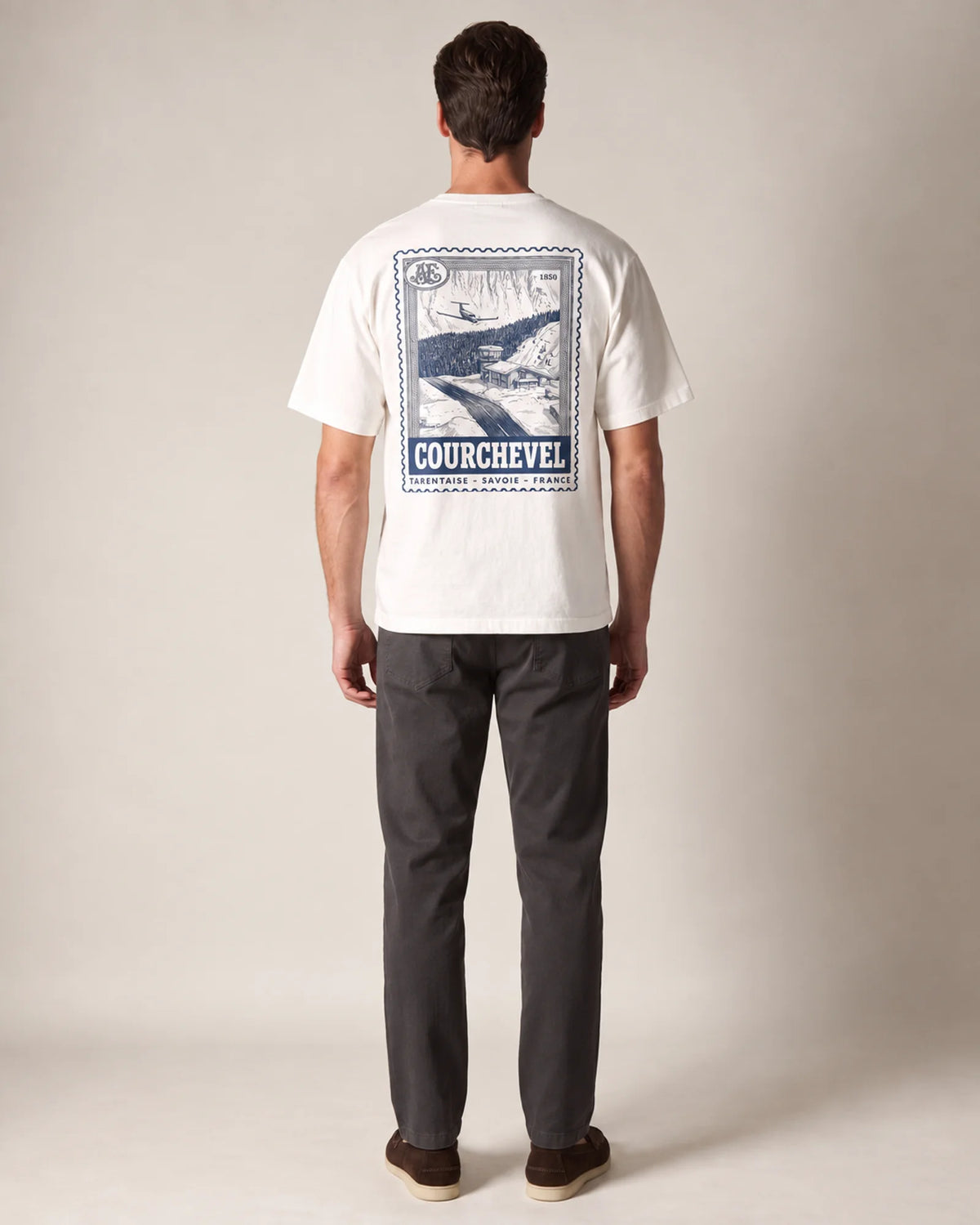 Model wearing the white Courchevel tee in a studio, back view