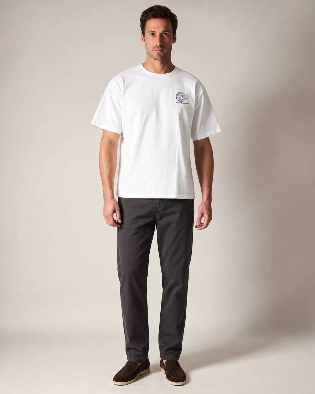 Model wearing the white Courchevel tee in a studio, front view