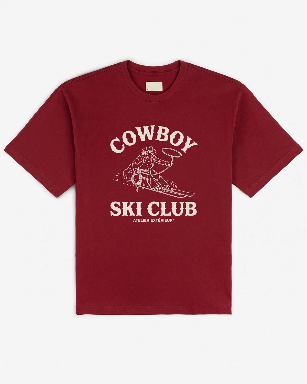 Deep red heavyweight cotton tee, front view, with a cream Cowboy Ski Club print of a lasso-swinging cowboy on skis