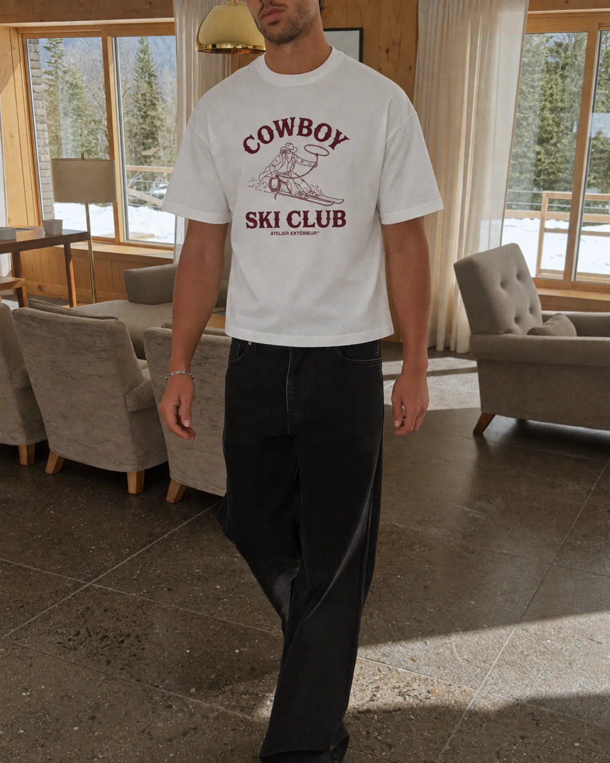 Man wearing the Cowboy Ski Club Tee in white, on location