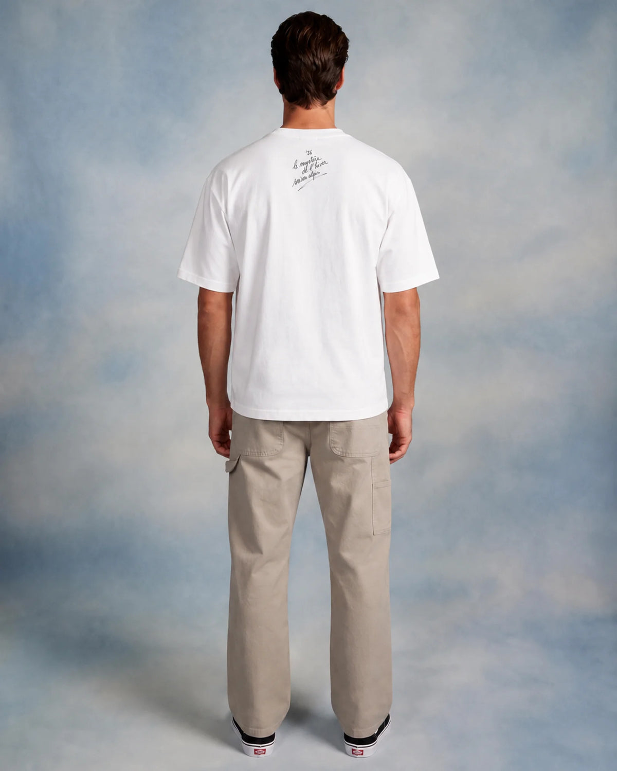 Model wearing the white Diana tee in a studio, back view