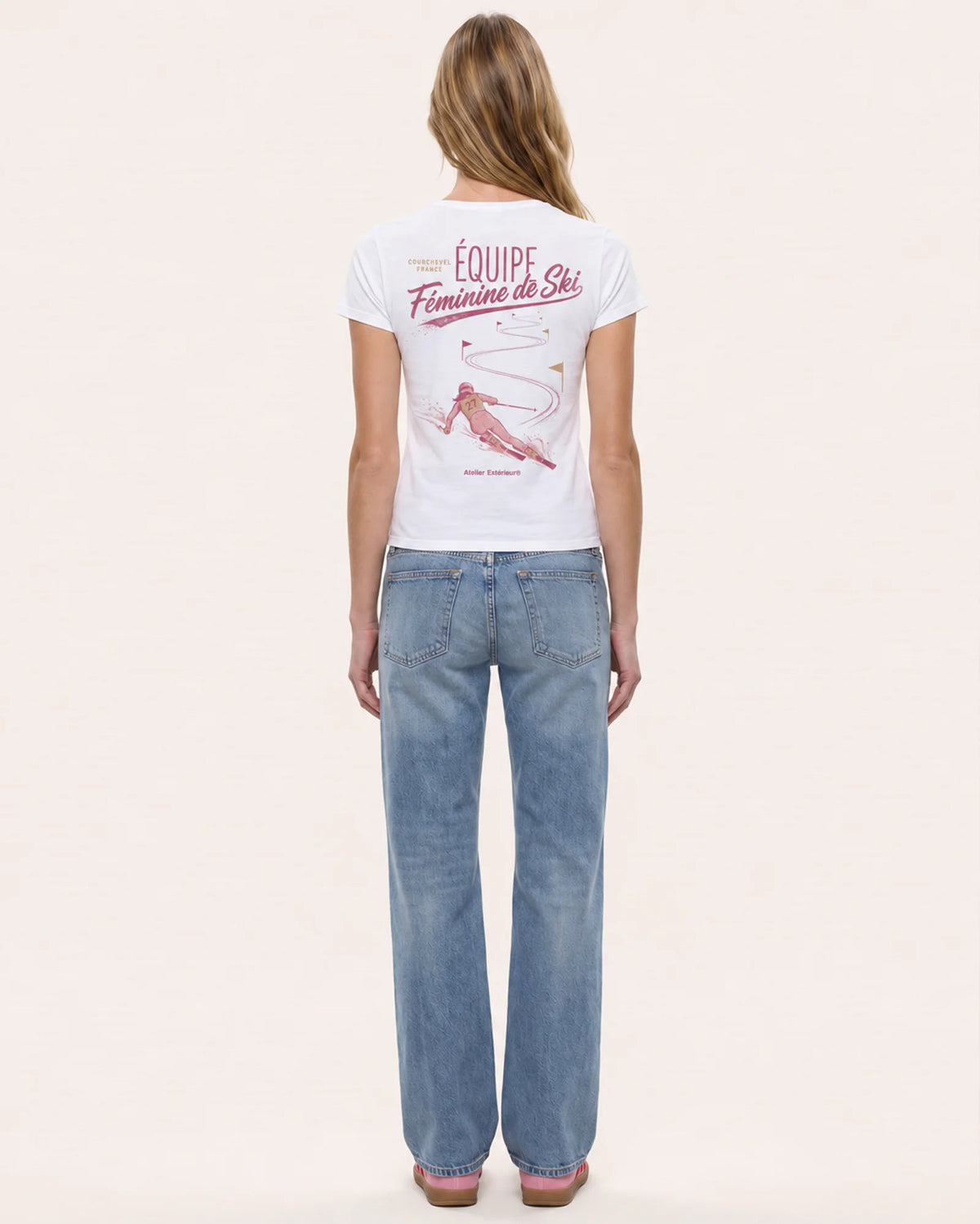 Model wearing the Équipe Féminine de Ski women's tee, back view, showing the race poster print