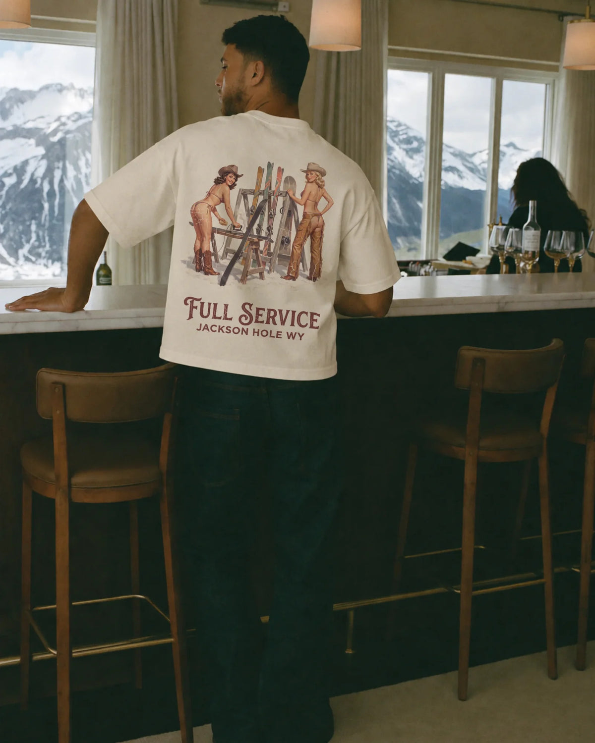 Man wearing the Full Service Tee in ecru, on location
