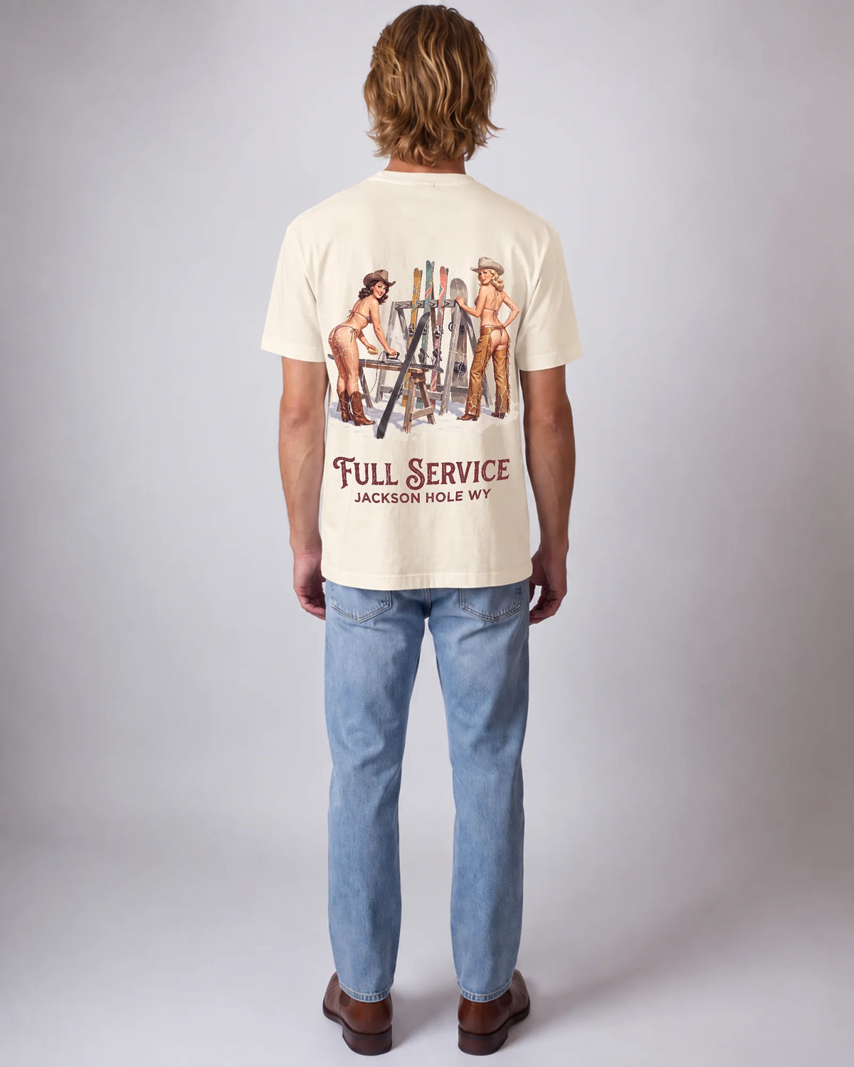 Model wearing the ecru Full Service tee in a studio, back view
