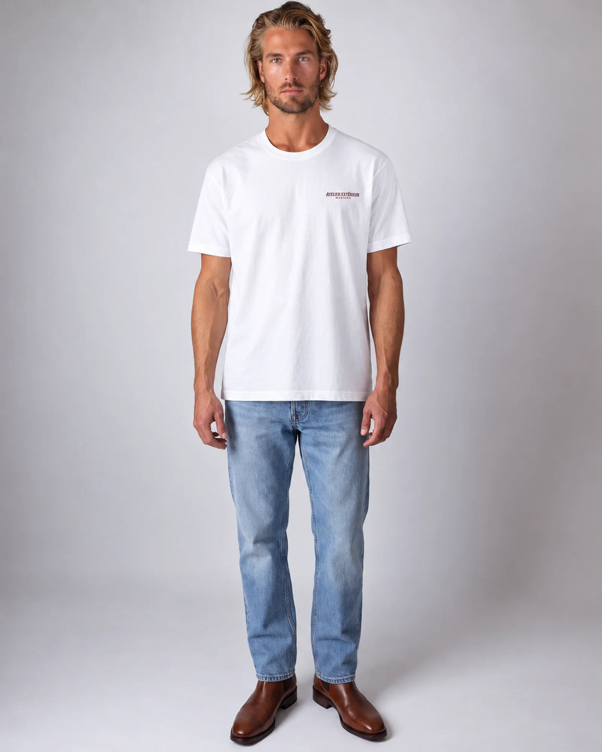 Model wearing the white Full Service tee in a studio, front view
