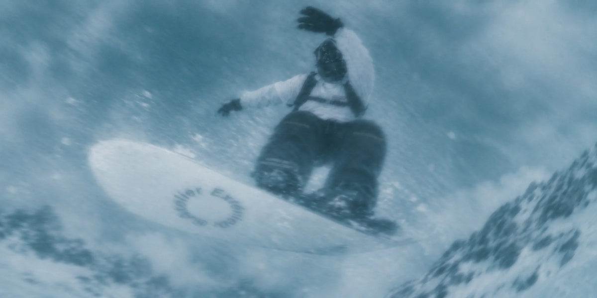 Snowboarder mid-air in powder