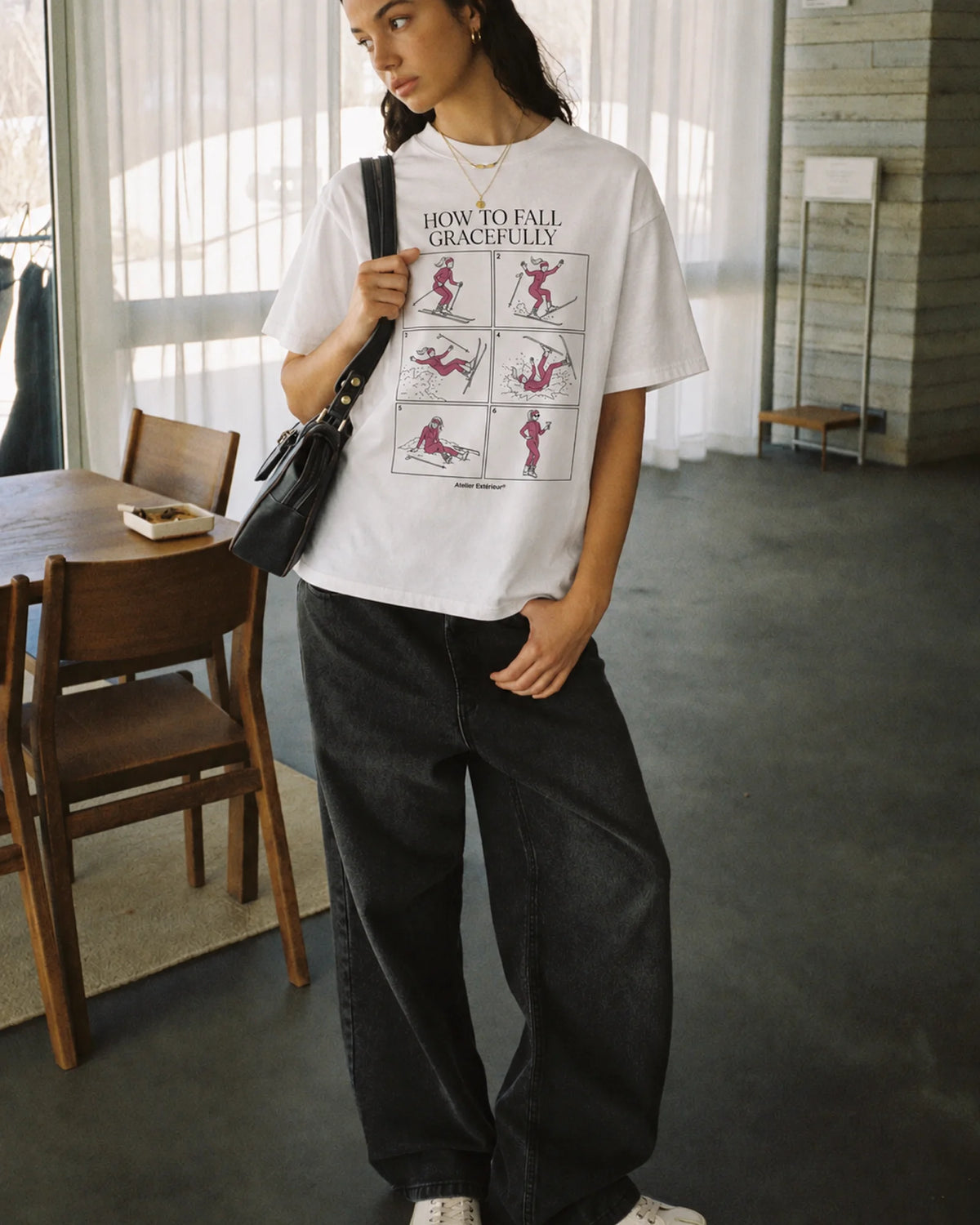 Woman wearing the How to Fall Women's Tee, on location