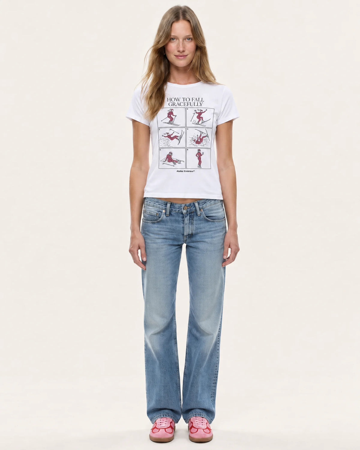 Model wearing the How to Fall women's tee with straight-leg jeans, front view