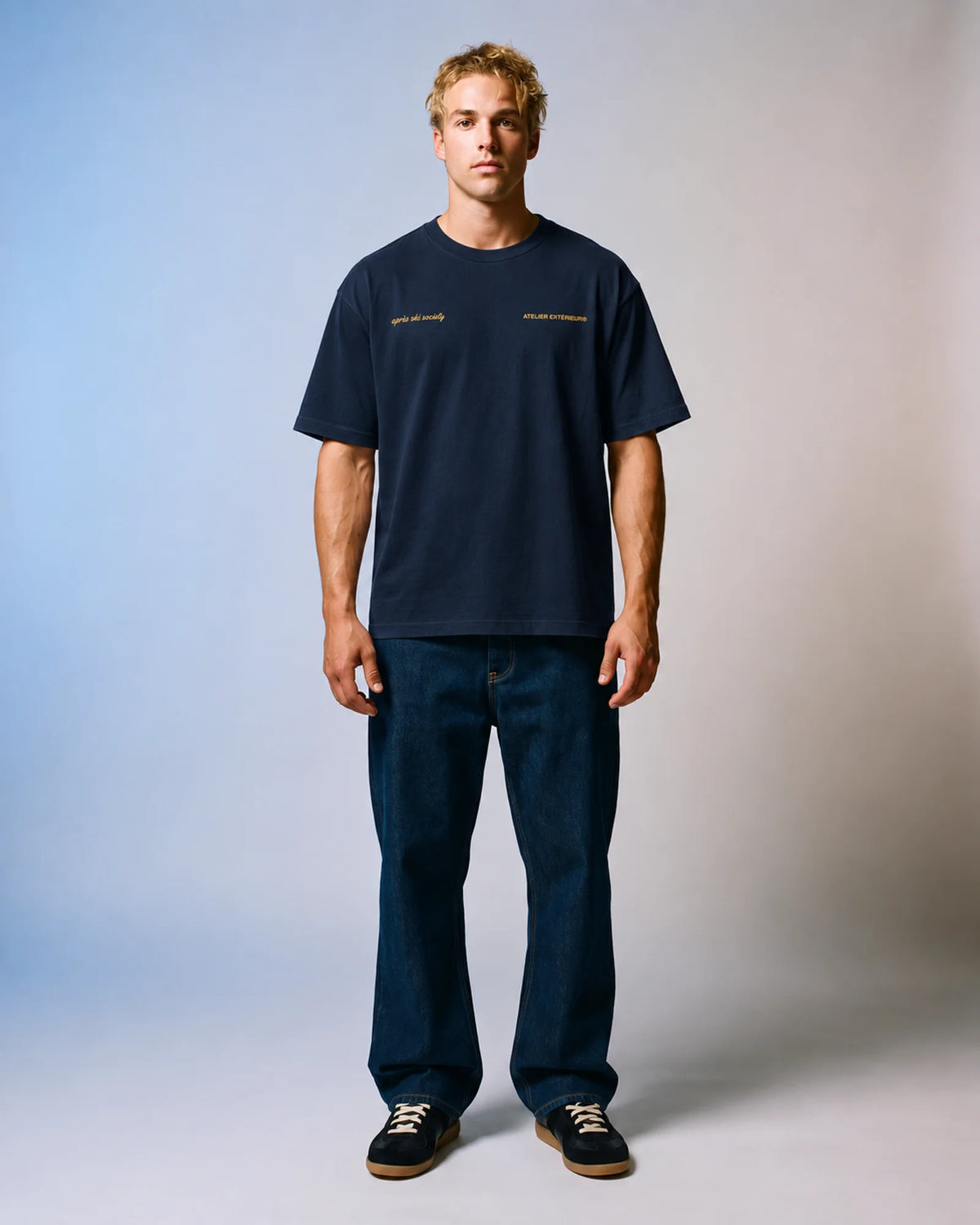 Studio model wearing the navy Après Ski Instructor tee, front view