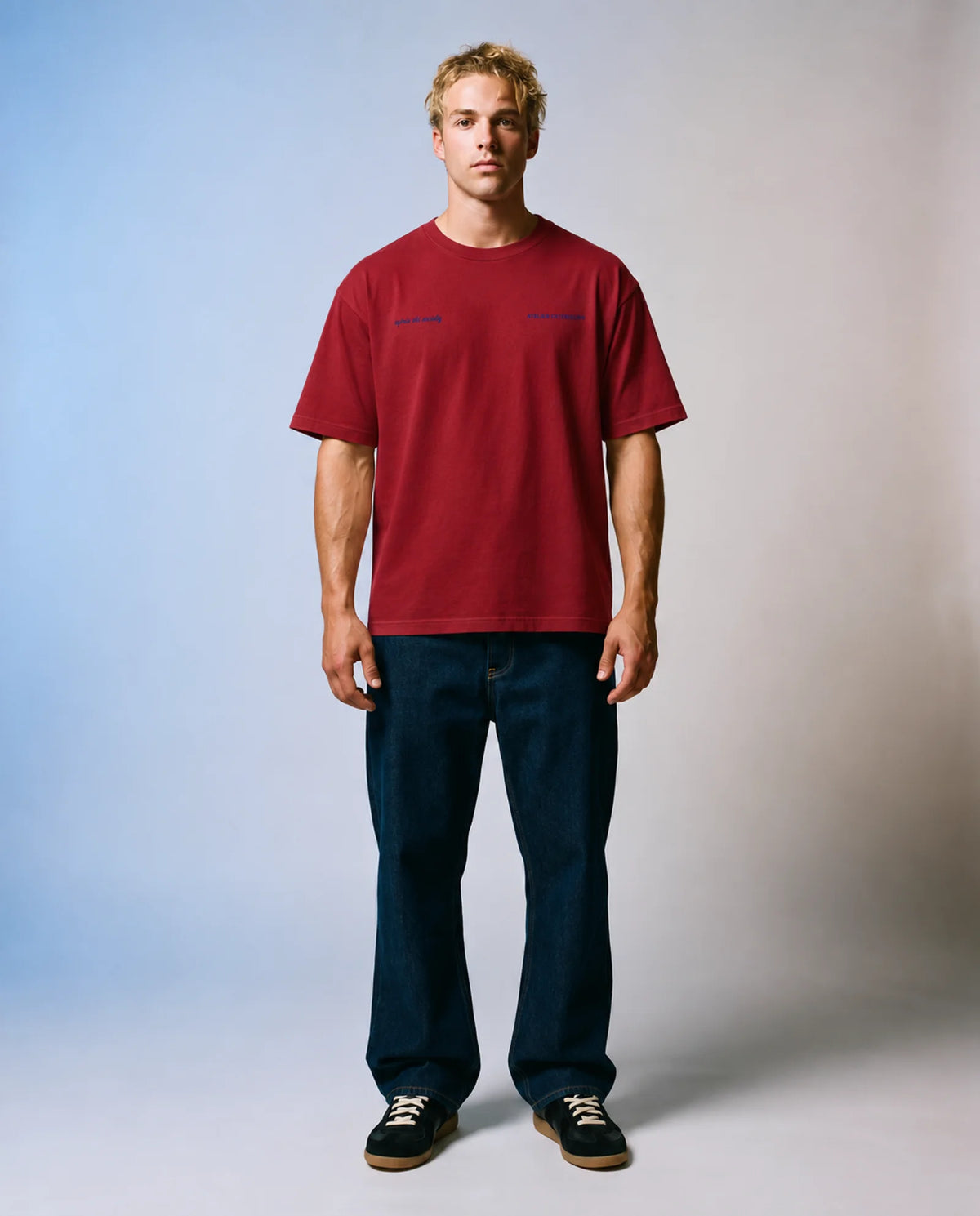 Studio model wearing the red Après Ski Instructor tee, front view