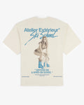 Ecru cotton Julia tee, back view, with a hand-painted Ski School illustration in blue