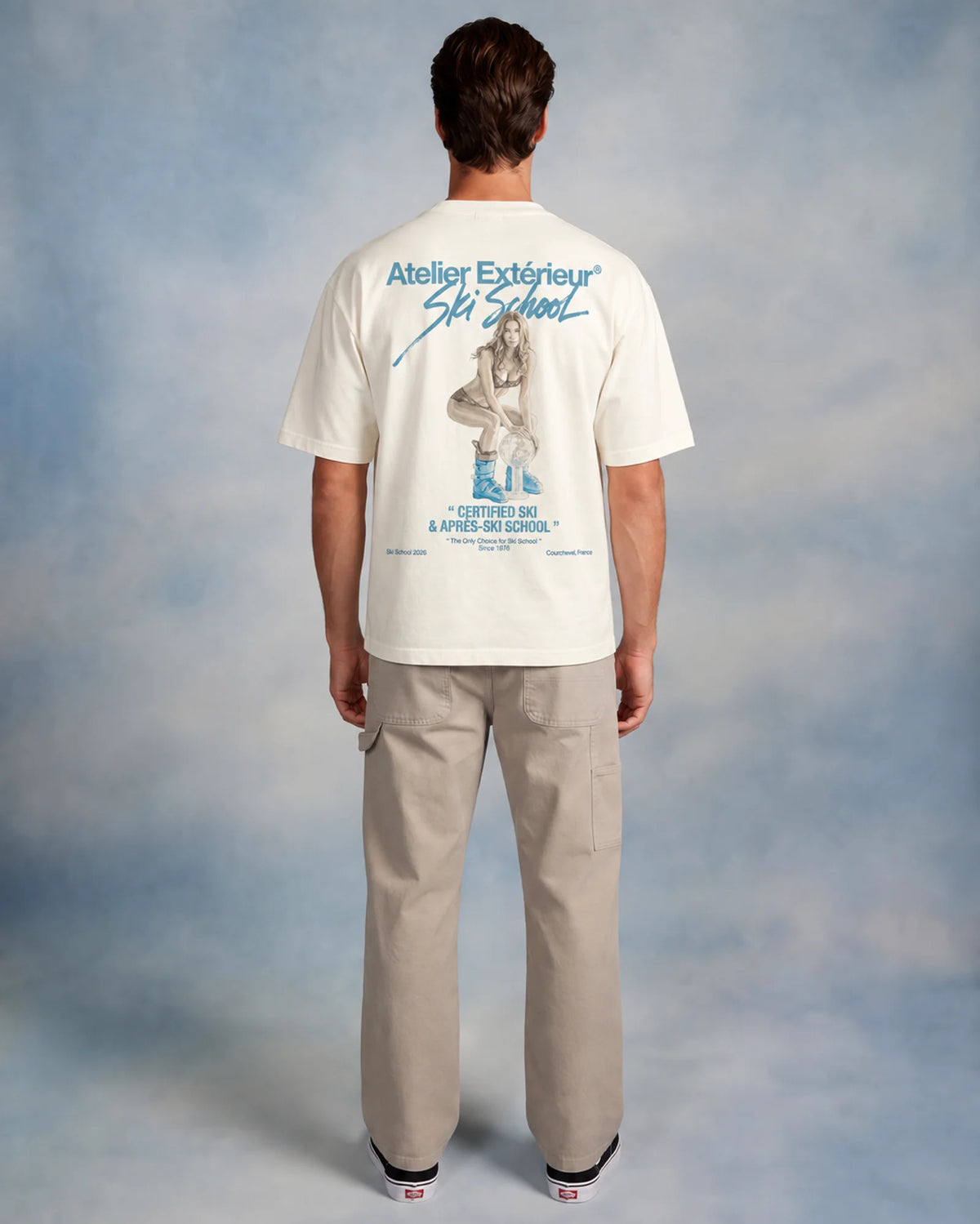 Model wearing the white Julia tee in a studio, back view