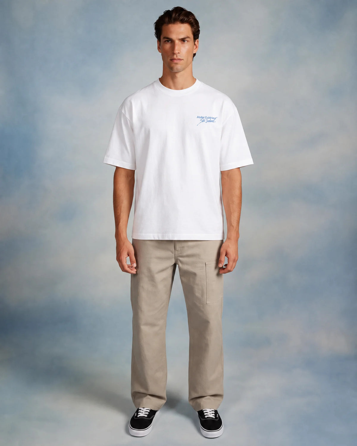 Model wearing the white Julia tee in a studio, front view