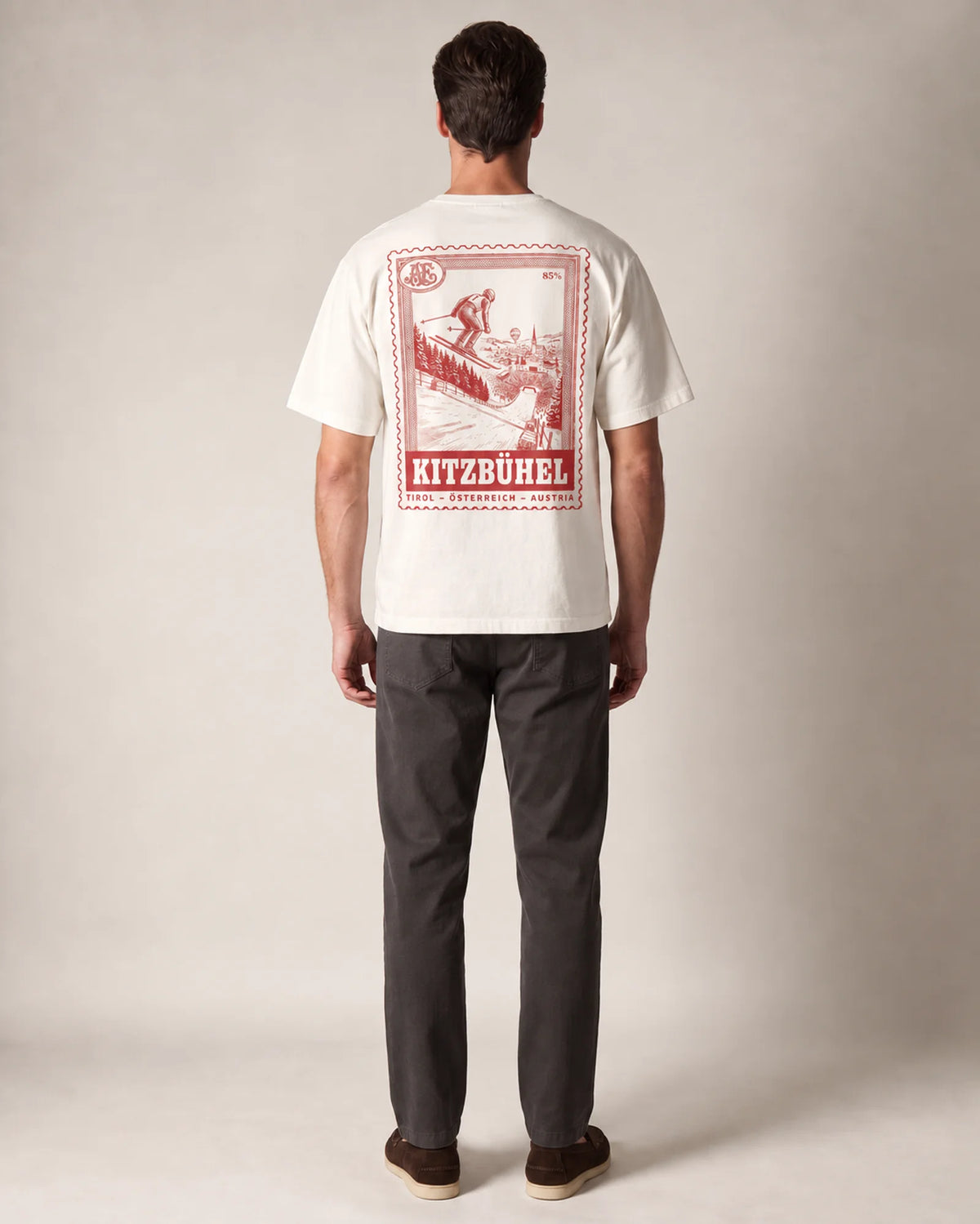 Model wearing the ecru Kitzbühel tee in a studio, back view