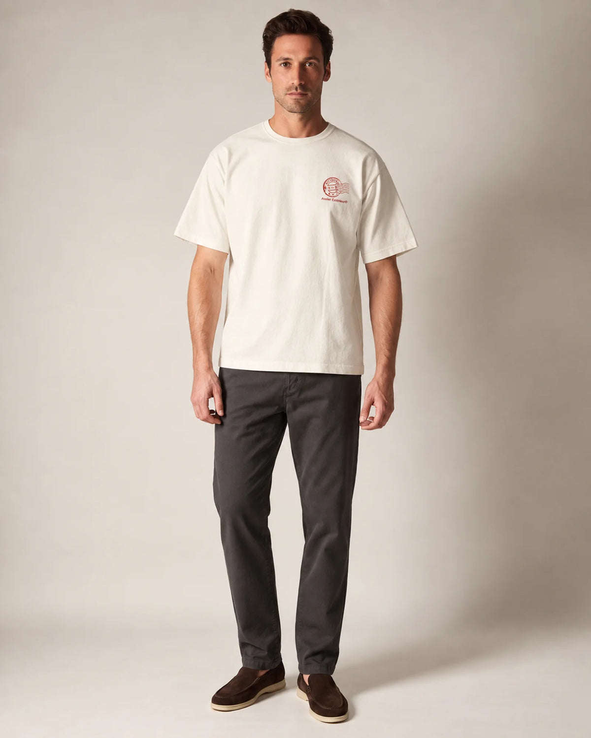 Model wearing the ecru Kitzbühel tee in a studio, front view
