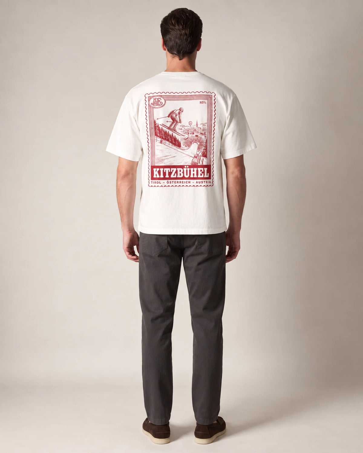 Model wearing the white Kitzbühel tee in a studio, back view