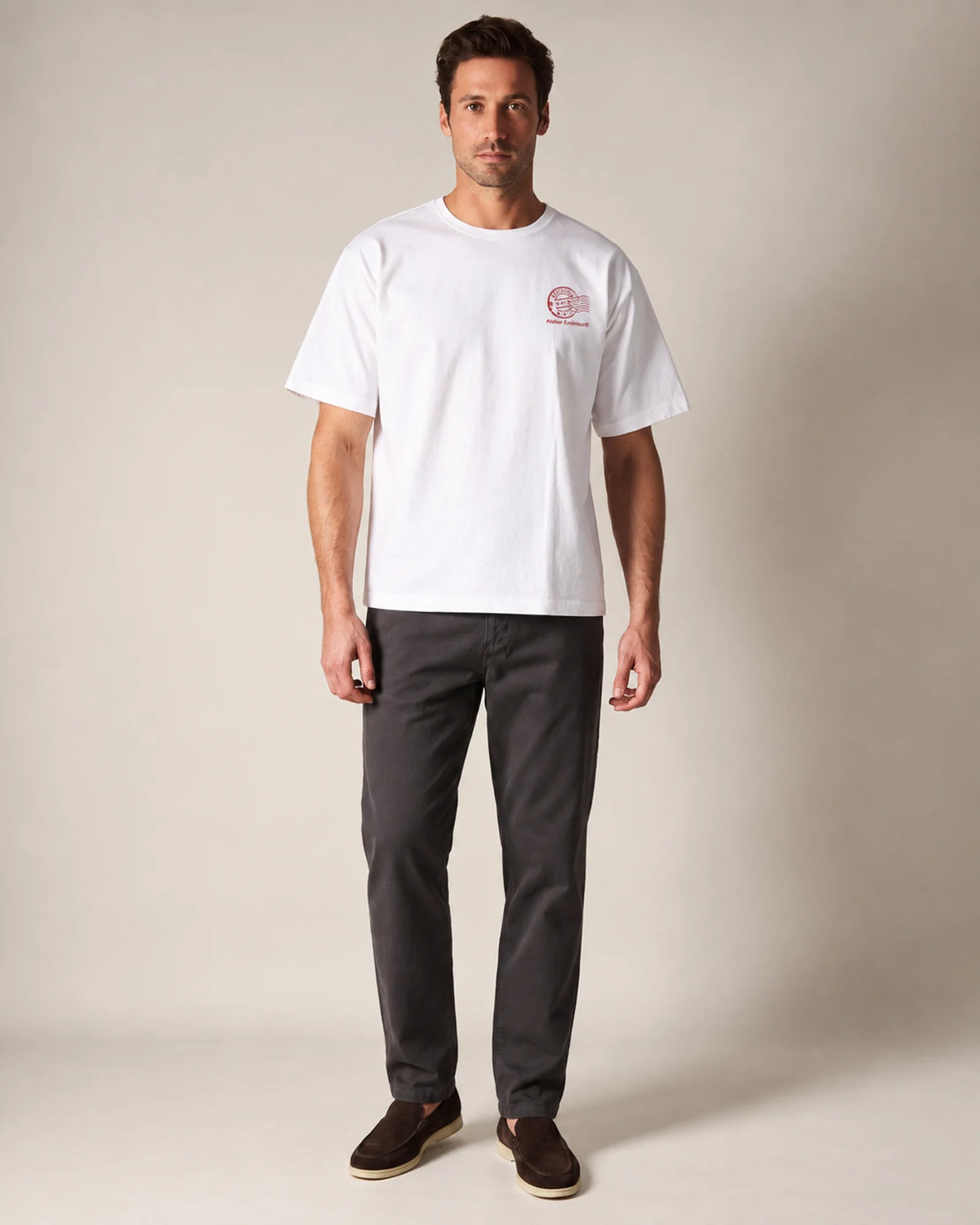 Model wearing the white Kitzbühel tee in a studio, front view