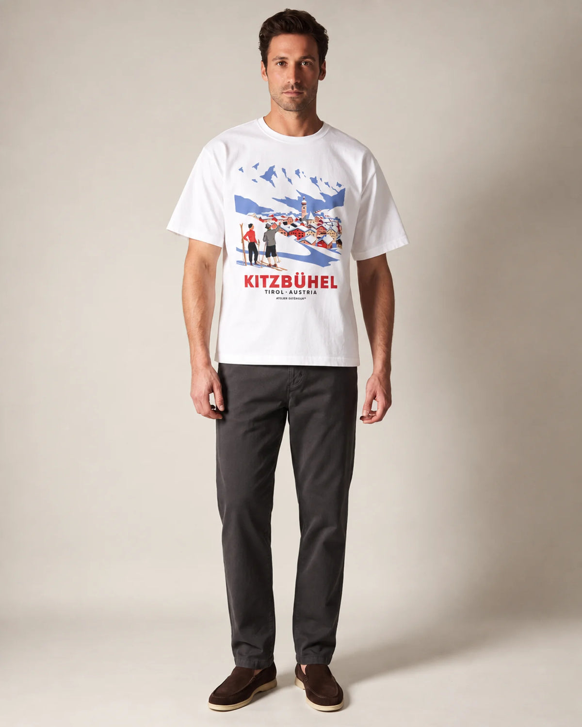 Model wearing the white Kitzbühel Vintage tee in a studio, front view