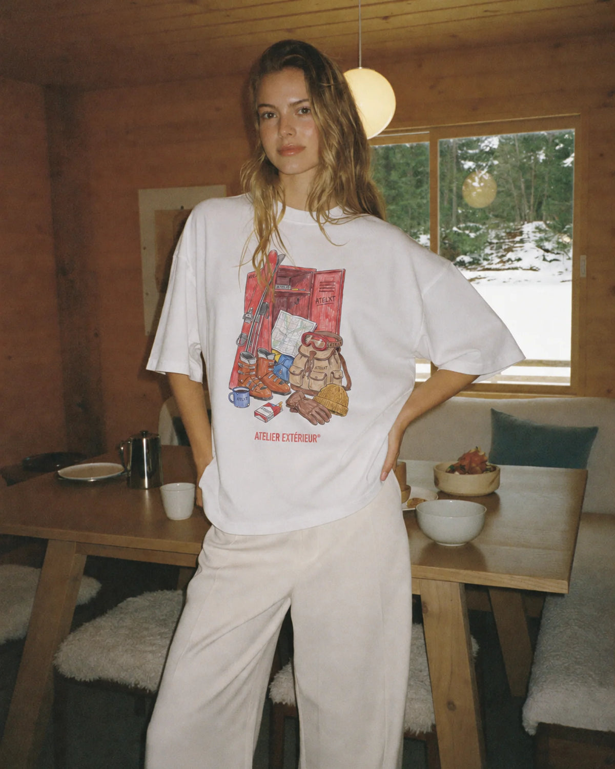 Woman wearing the white Locker tee outdoors, front view