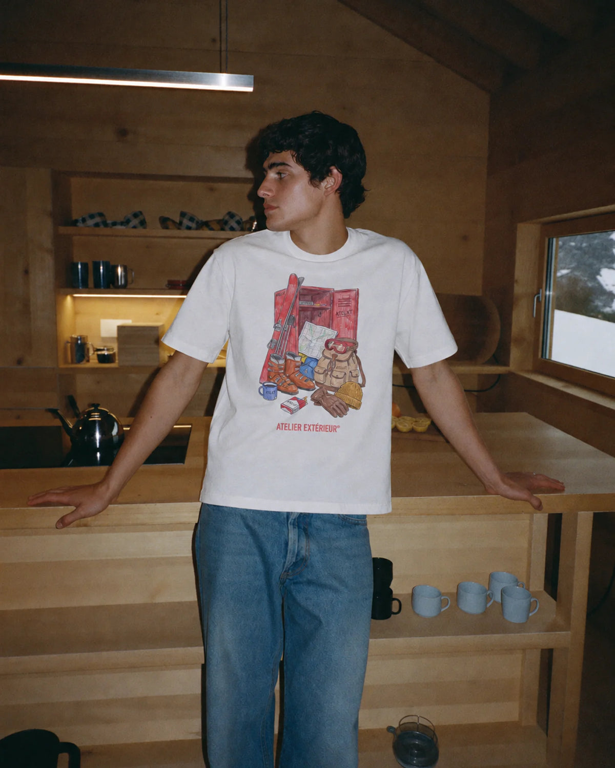 Man wearing the white Locker tee outdoors, front view