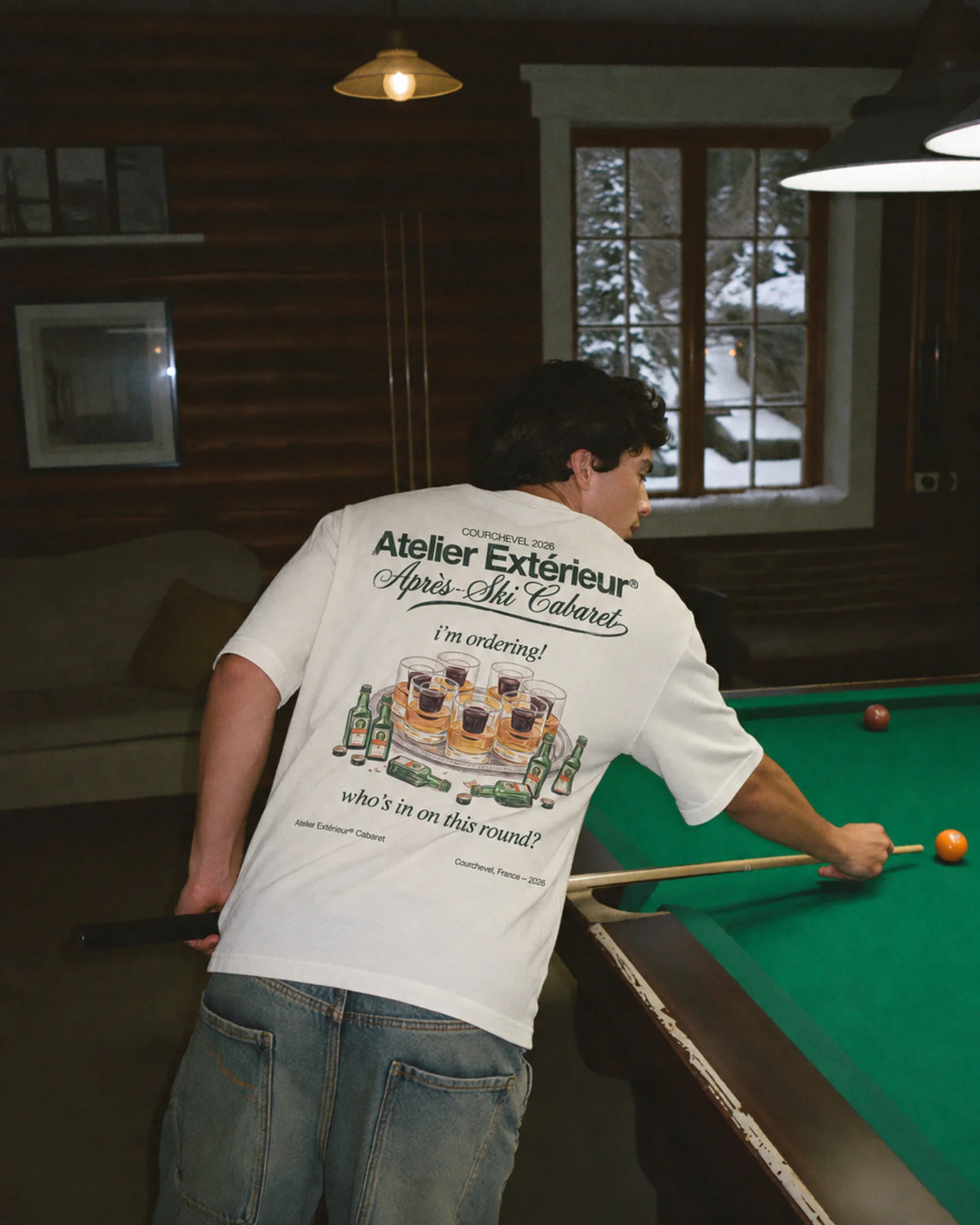 Man wearing the ecru My Round tee outdoors, showing the back print