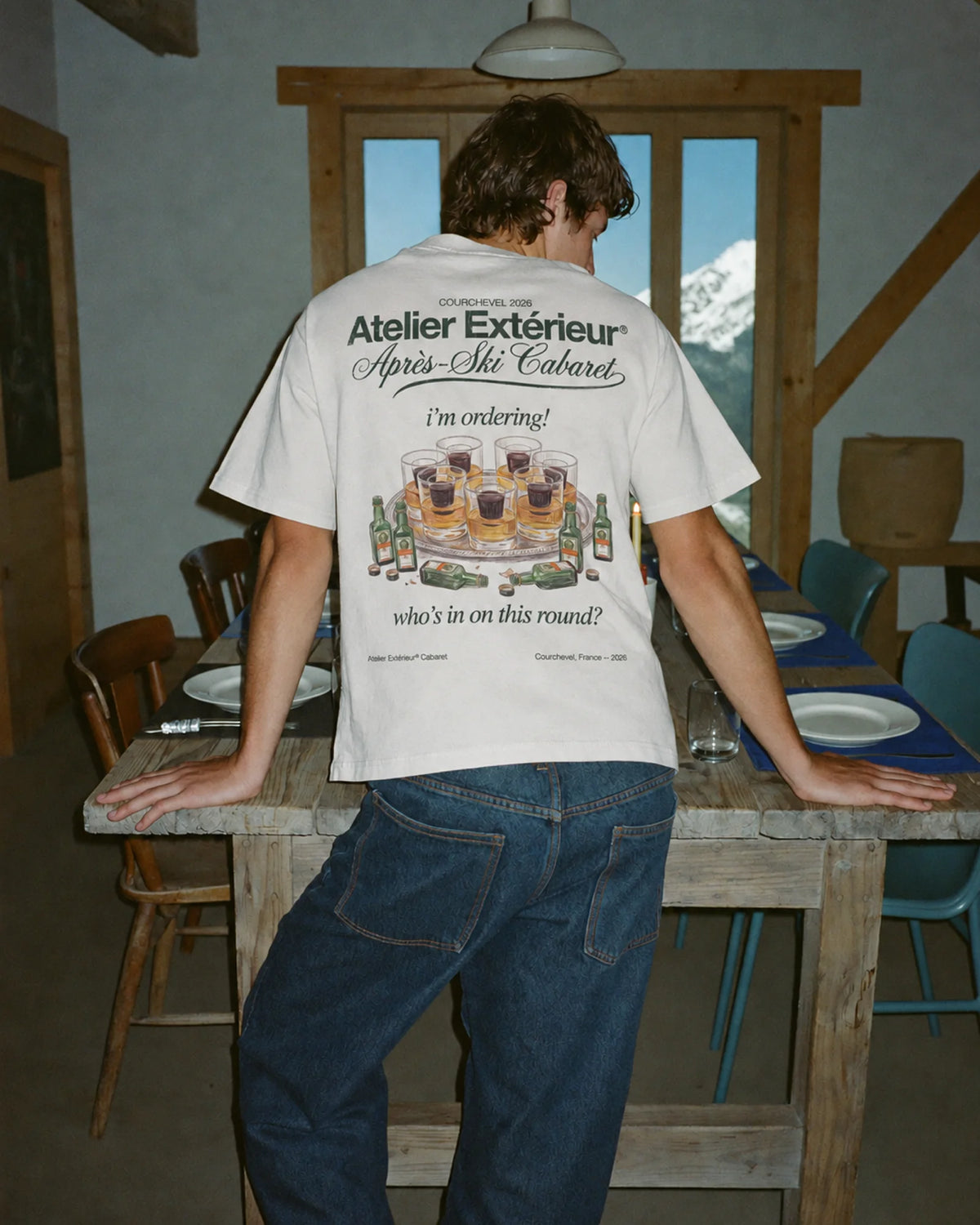 Man wearing the white My Round tee outdoors, showing the back print