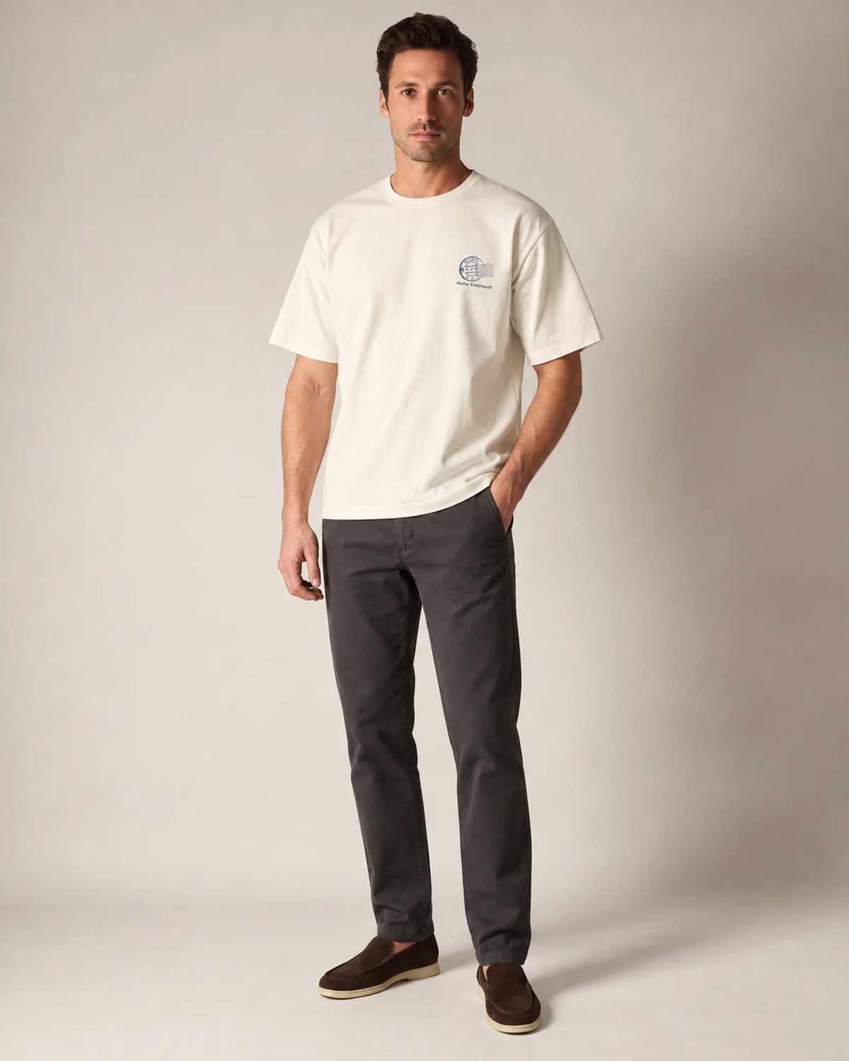 Model wearing the ecru Niseko tee in a studio, front view