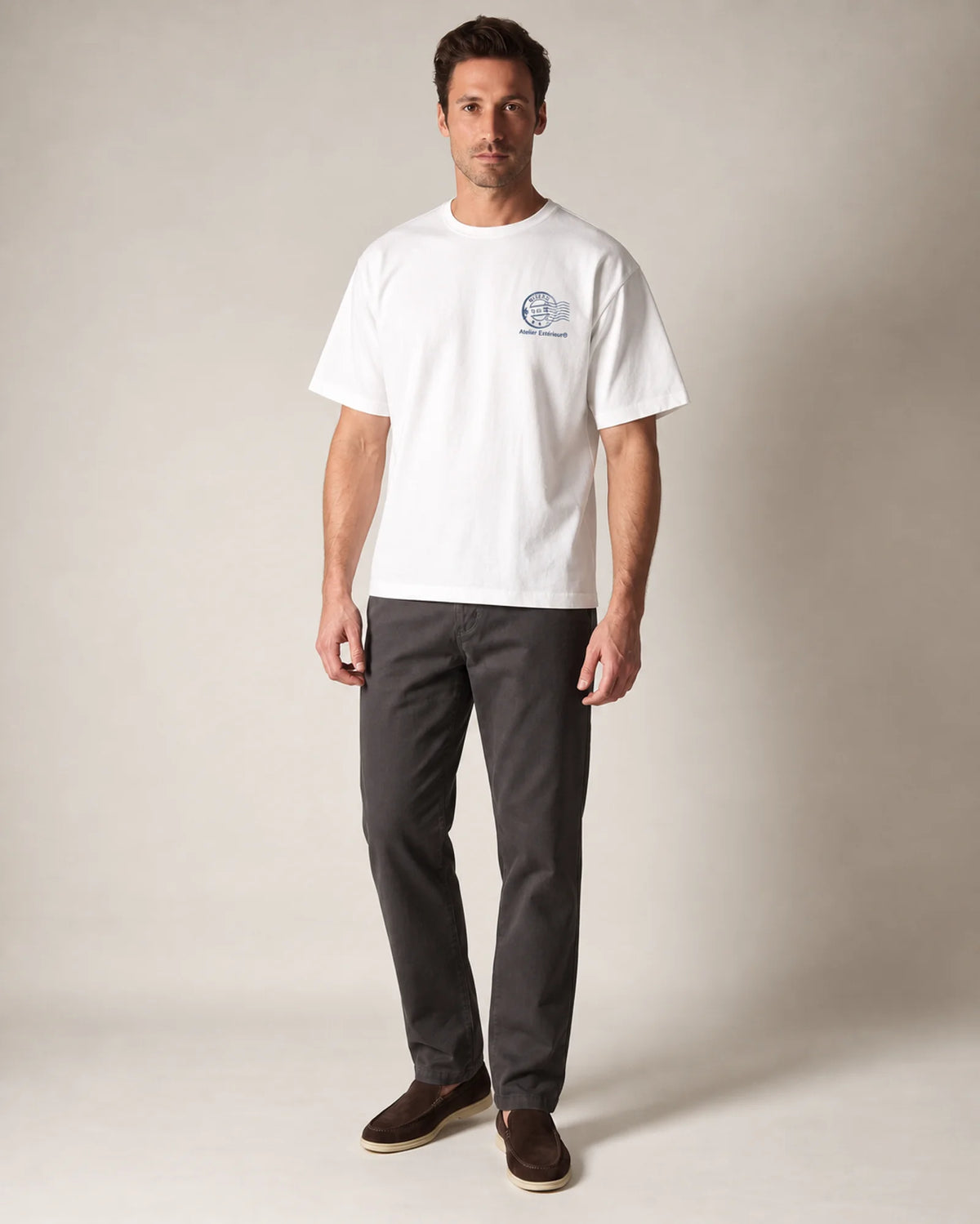 Model wearing the white Niseko tee in a studio, front view