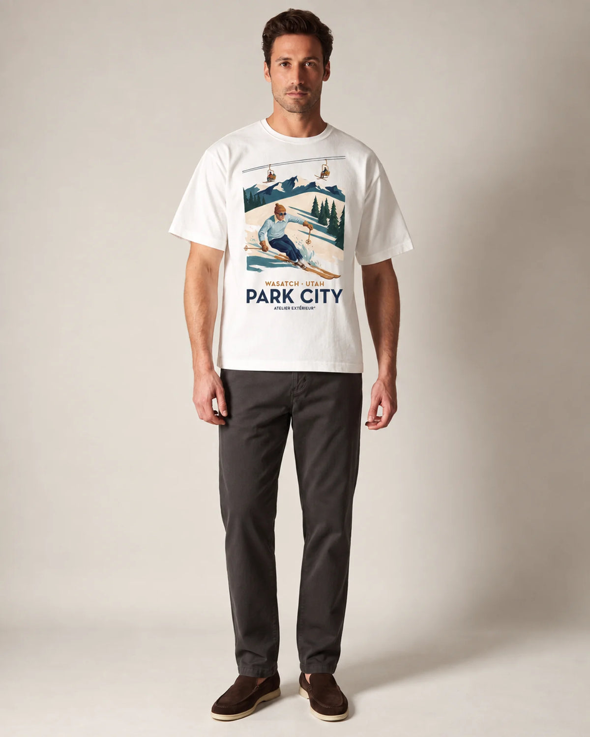 Model wearing the white Park City tee in a studio, front view
