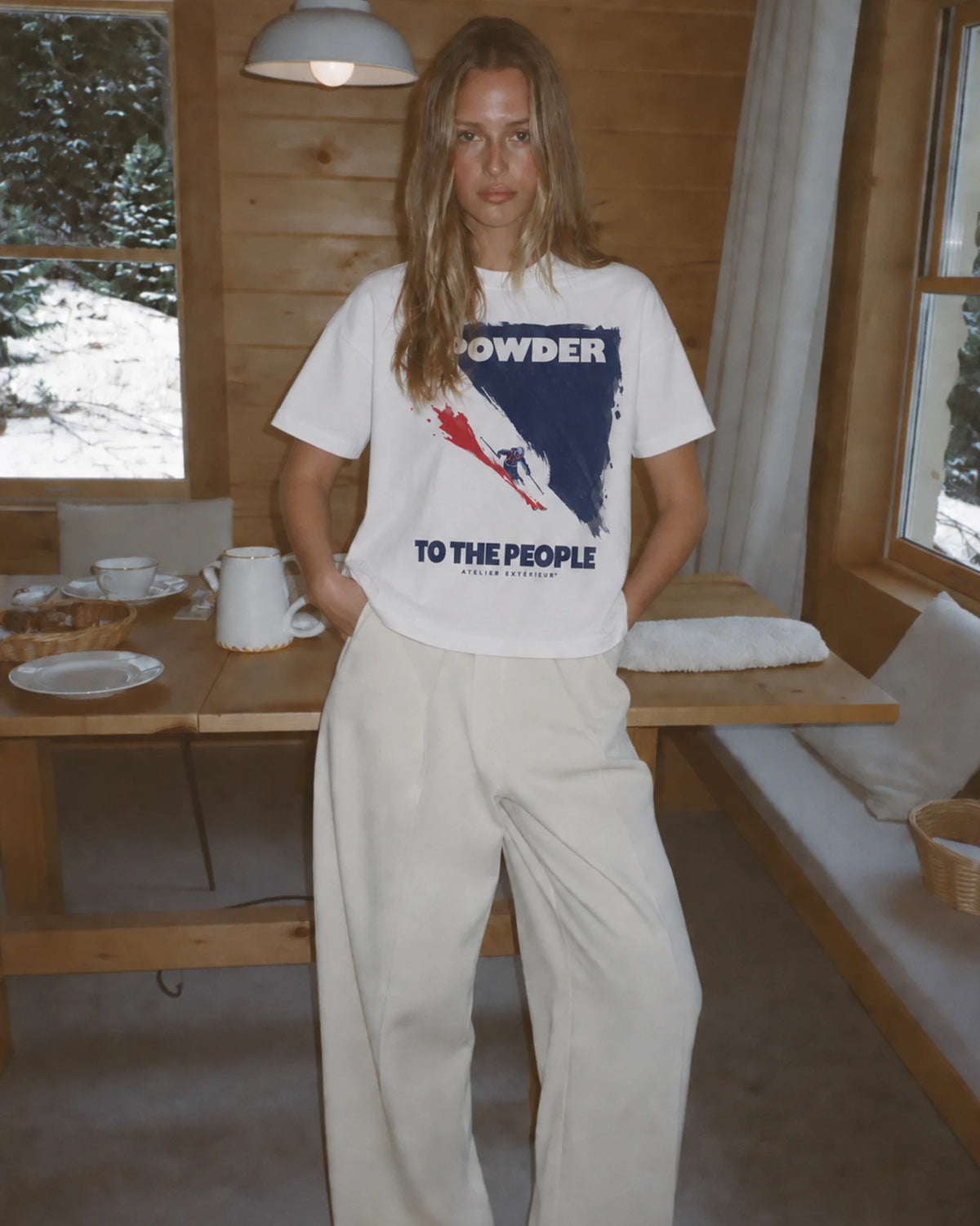 Woman wearing the ecru Powder to the People tee outdoors, front view